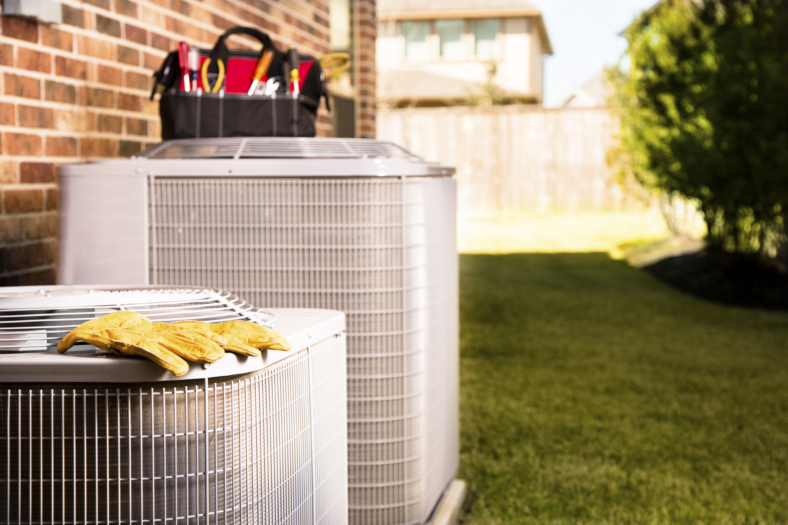 Pine Belt Heating & Air technician performing air conditioner maintenance