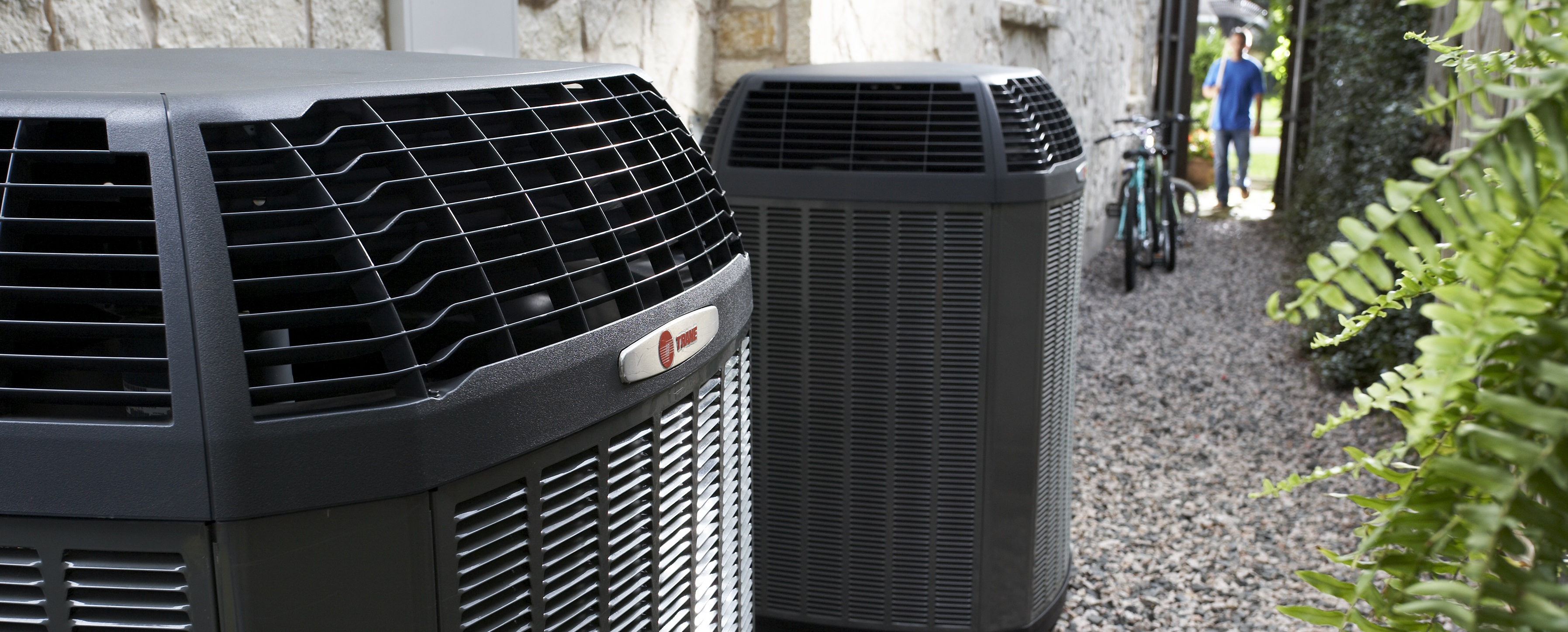 Trane air conditioners installed on the side of a home