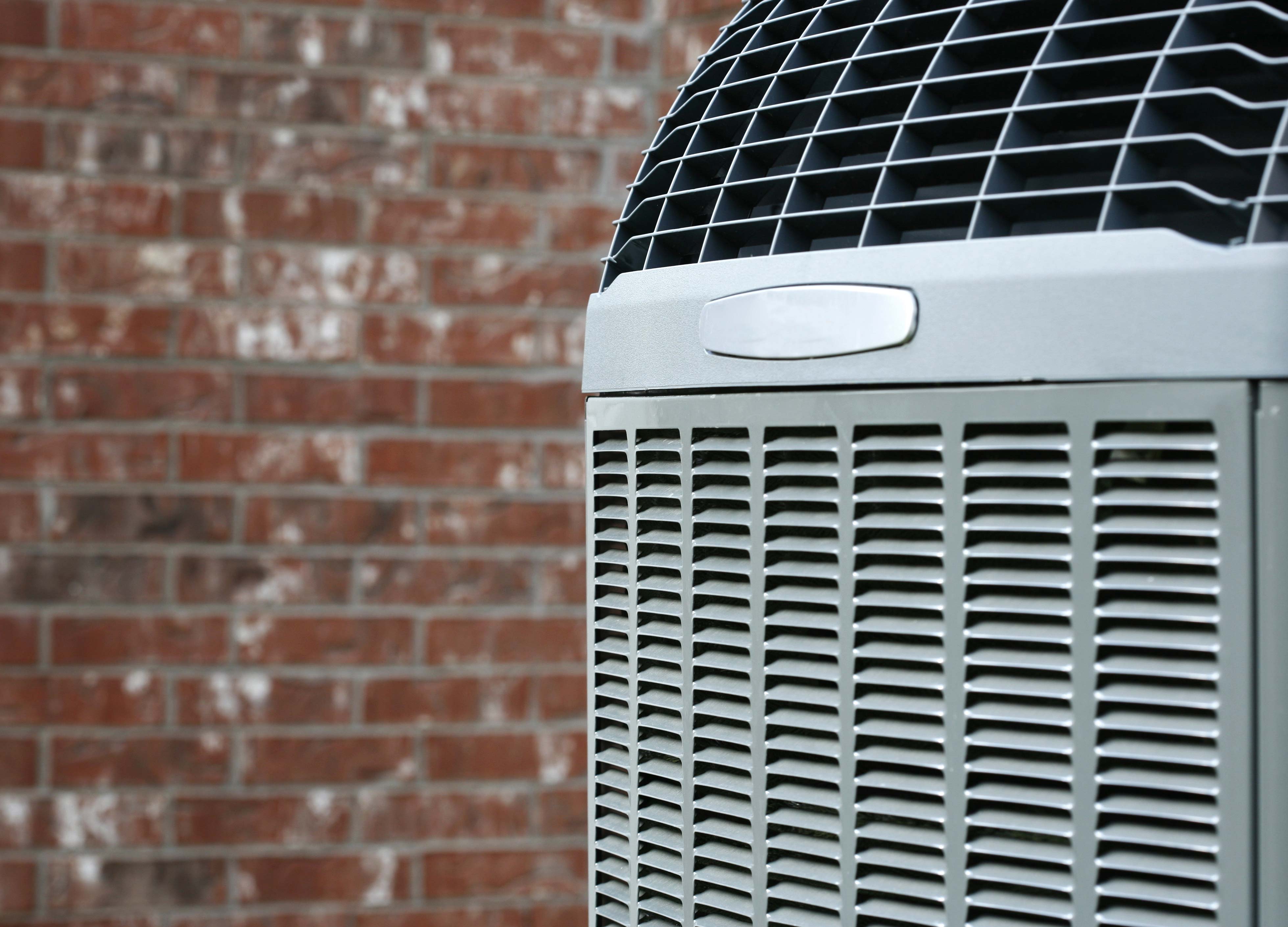 Pine Belt Heating & Air technician servicing an air conditioner